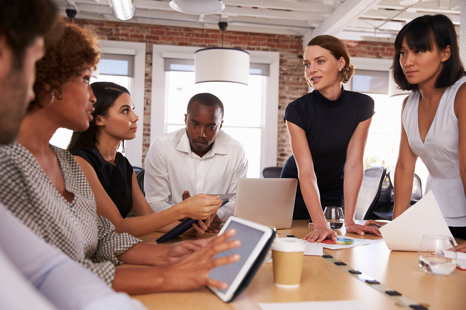 businesspeople-meeting-around-table-in-modern-offi-PYML4WH-1.jpg